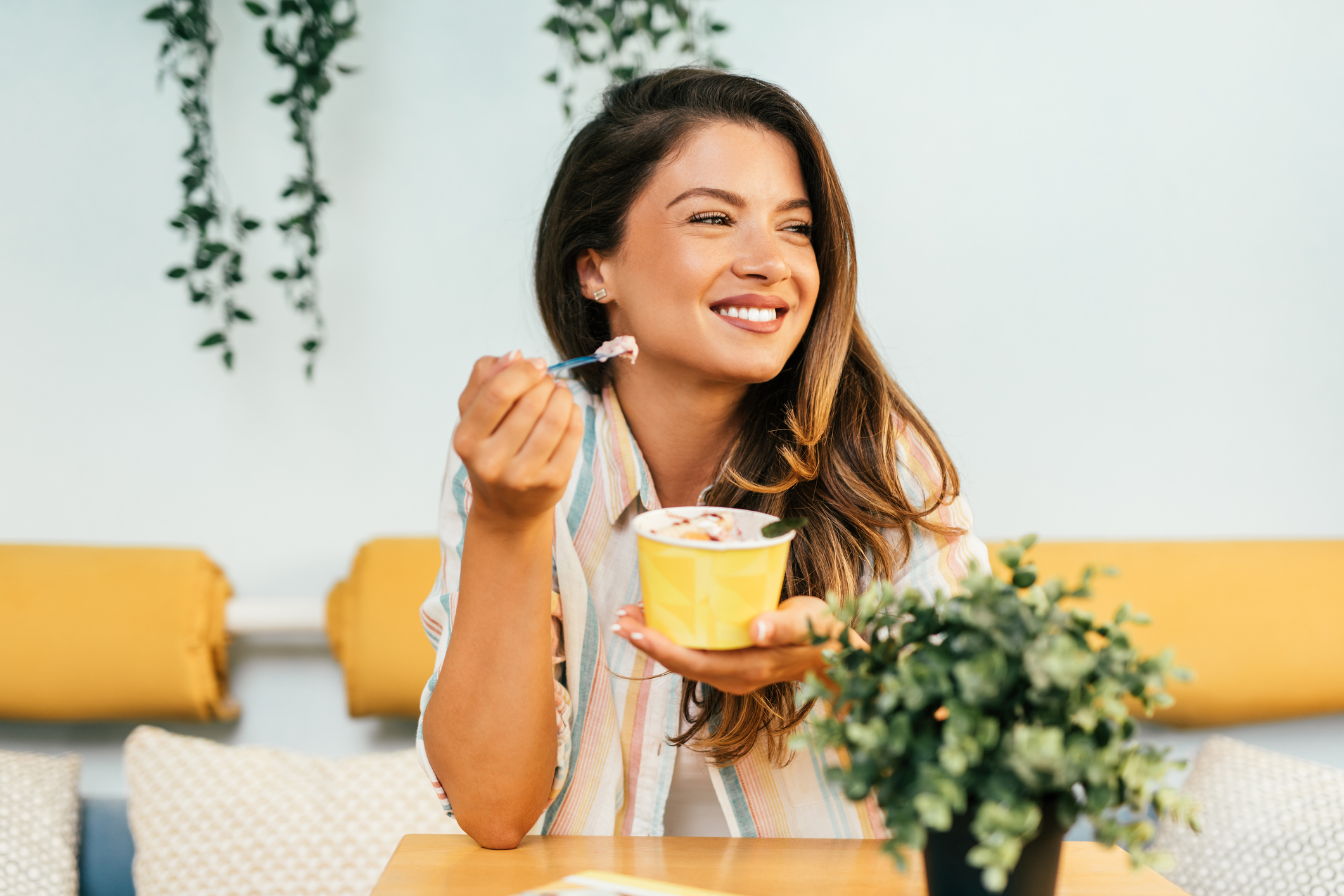 Happy young woman enjoying in rolled ice cream