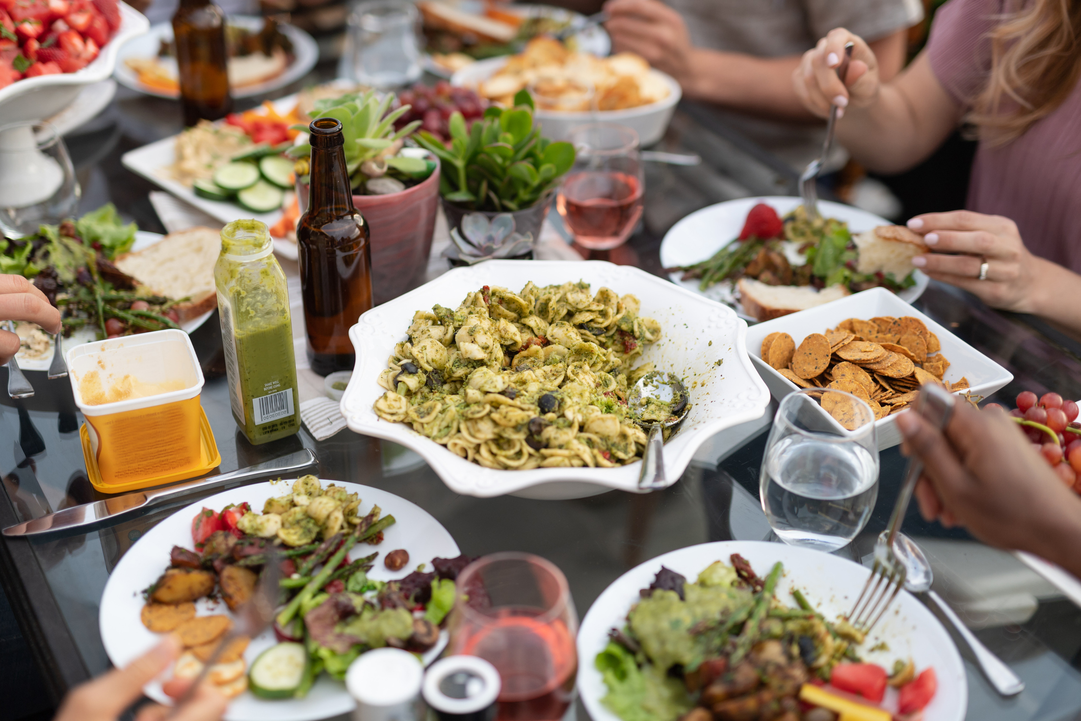 A group of young adult friends dining al fresco on a patio A group of young adult friends dining al fresco on a patio