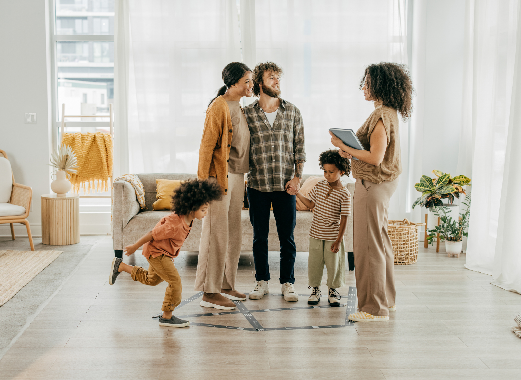 Family visiting new home with realtor and kids