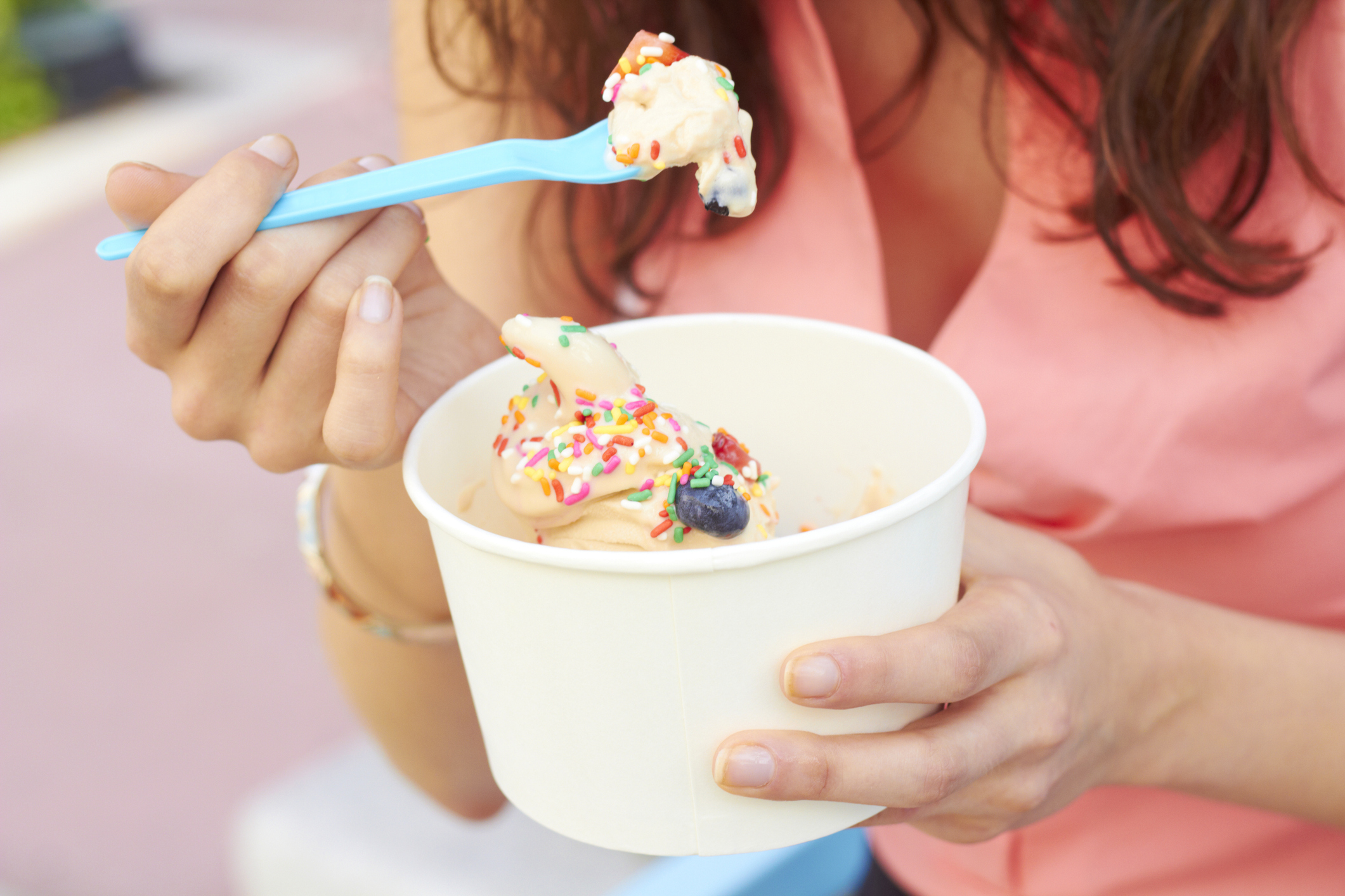 Woman Eating Frozen Yogurt With Berries