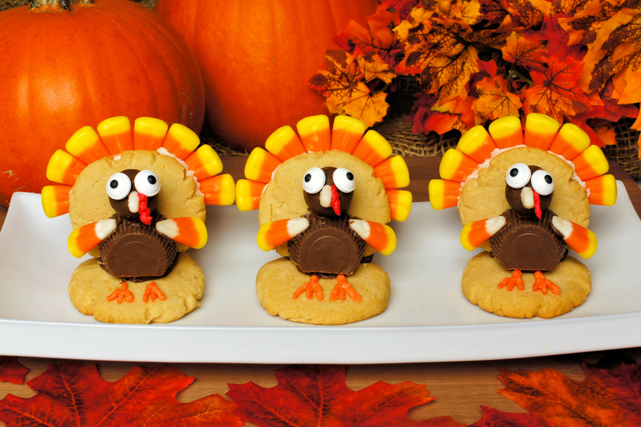 Thanksgiving turkey shaped cookies with autumn leaves and pumpkins